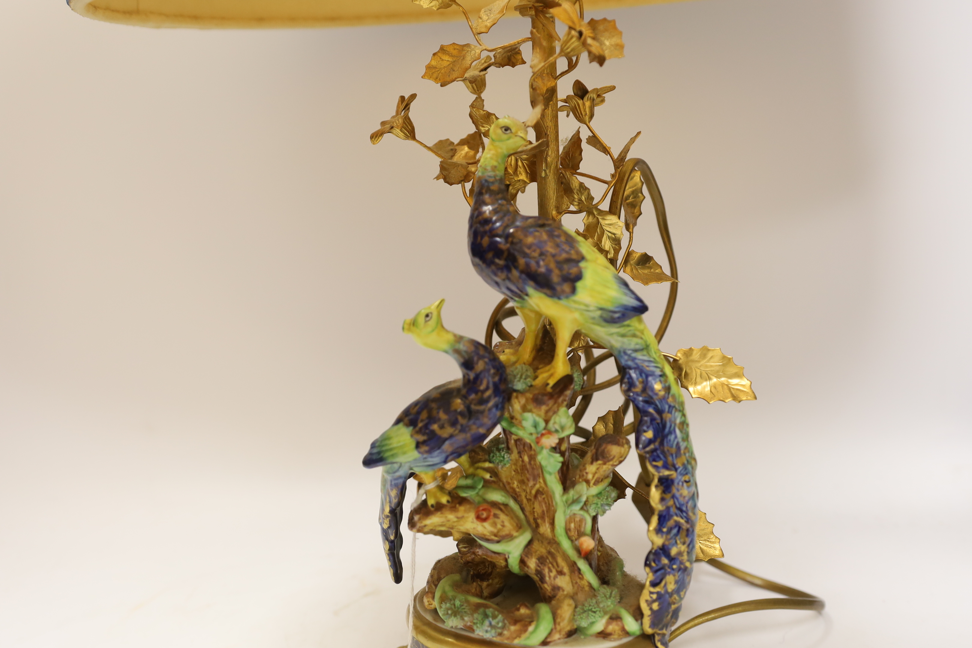 A pair of Sevres style porcelain and gilt metal ‘peacock’ lamps and shades, 60cm total height